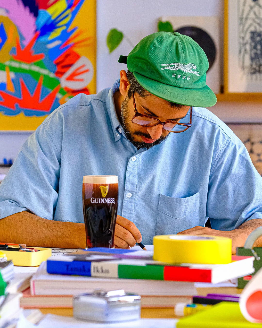 Sebastian Curi drawing in his studio for the Guinness summer collaboration