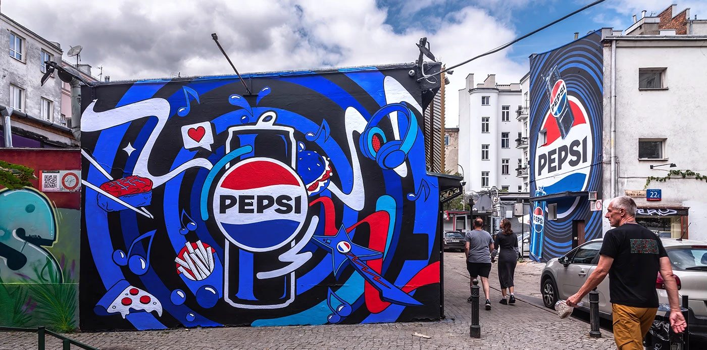 Blue Pepsi mural illustrated by Rui Granjo in its daytime urban setting