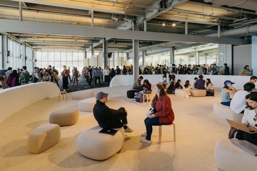 Make with Notion 2024 event space with participants gathered in a conversation area